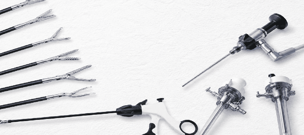 Advanced laparoscopic surgical instruments and trocars arranged on a textured white background for minimally invasive surgery procedures