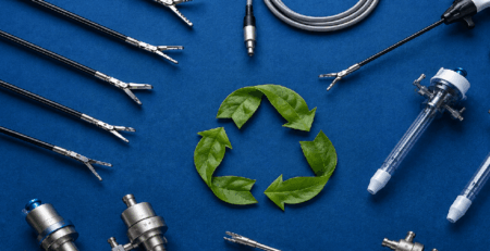 Reusable laparoscopic surgical instruments and trocars arranged around a green leaf recycle symbol on a blue textured background
